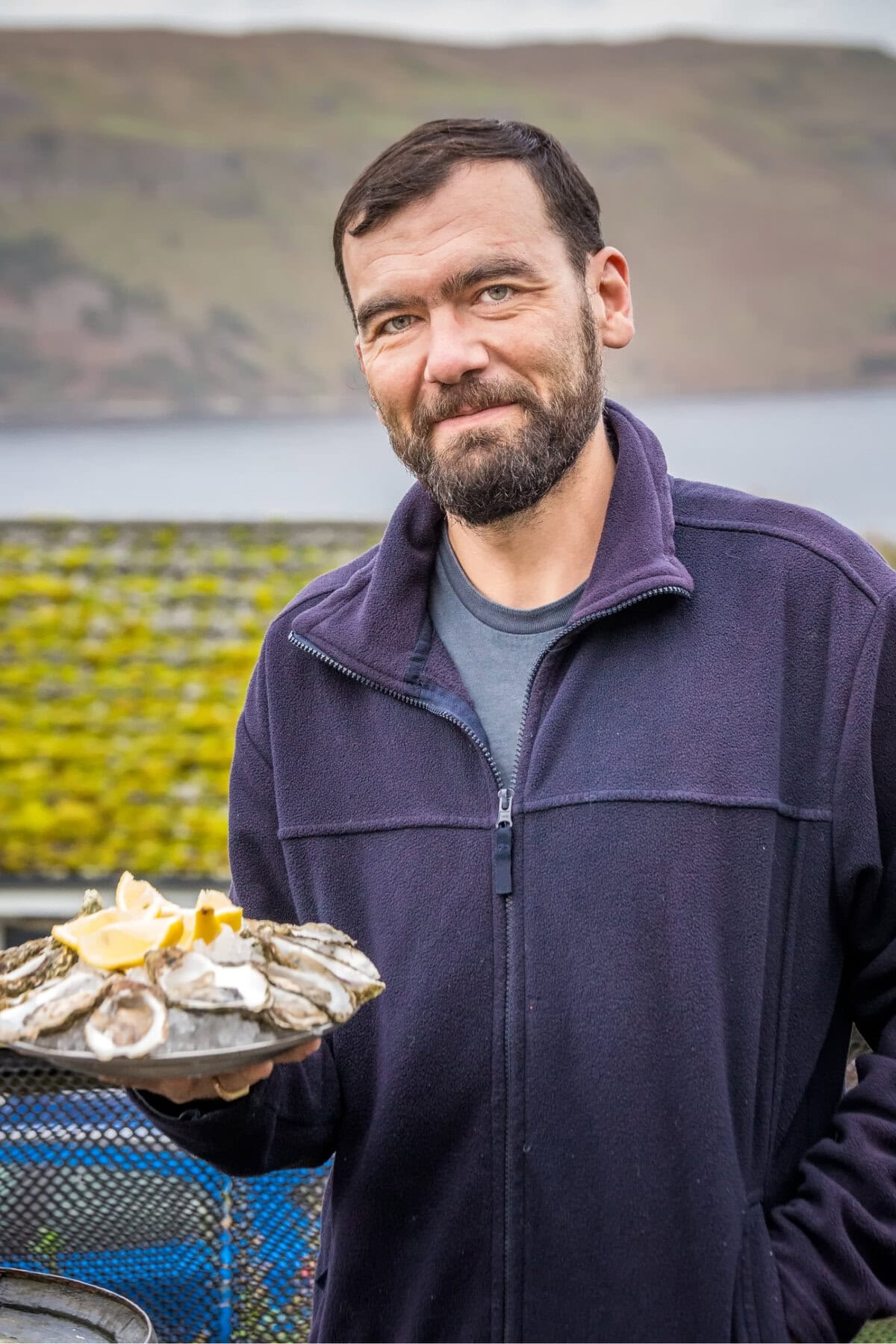 _ Man Showing Plate of Oysters on the Isle of Skye, Scotland, UK
