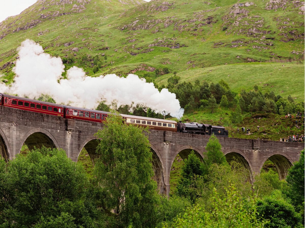 Glenfinnan Viaduct with Jacobite Steam Train Crossing Through the Scottish Highlands